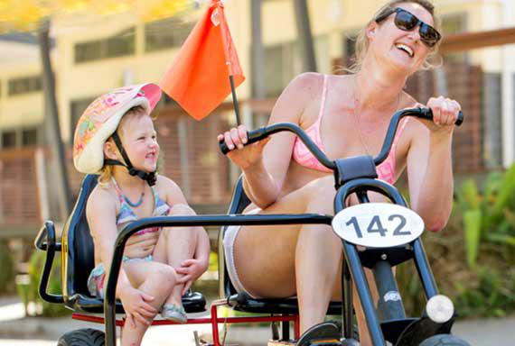 woman and girl in a peddle cart