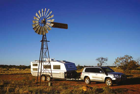 bushtracker caravan and 4WD in the outback with windmill