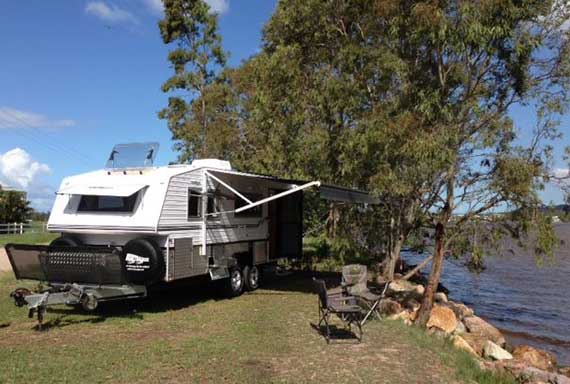 caravan with annex out next to lake