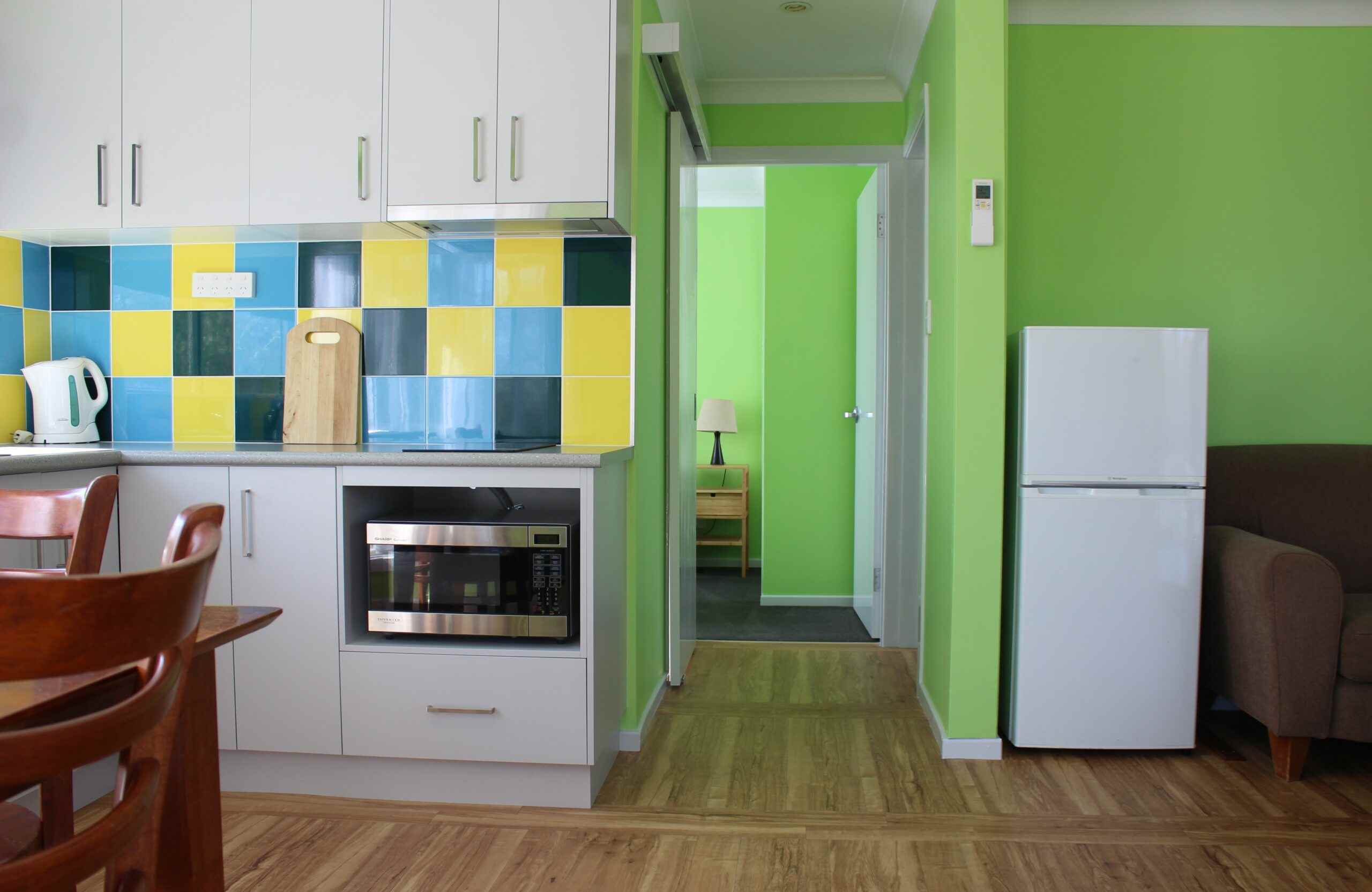 green walls, grey kitchen living area of cabin