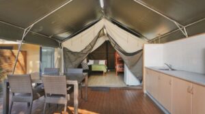main bed and living area of glamping tent