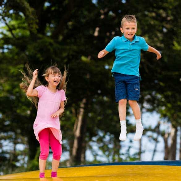 boy and girl on jumping pillow