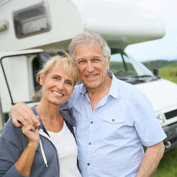 older couple in front of motorhome
