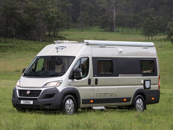 fiat torino xtra motorhome in a grassy field with trees in the back ground