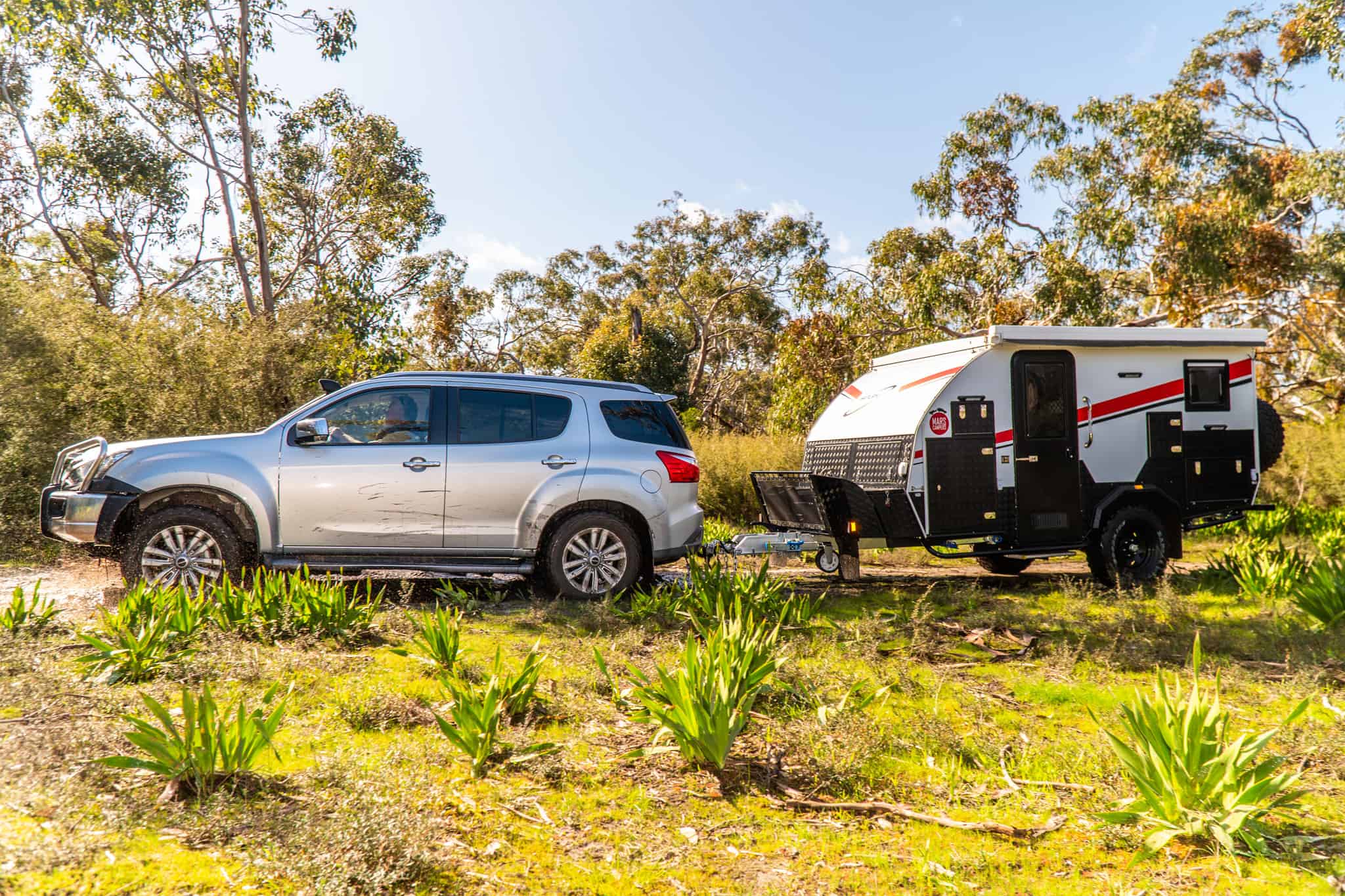 4WD towing hybrid caravan in bushland