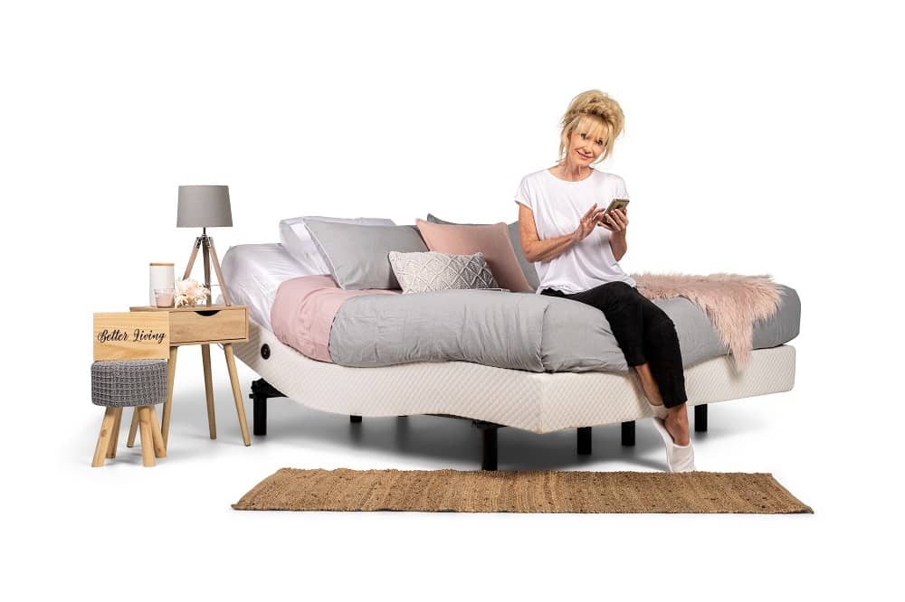 older woman sitting on the end of bed