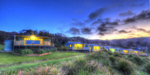 View of cabins at dusk with clear skies.