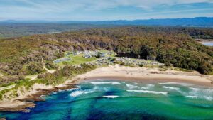 Aerial view of Beachcomber Holiday Park on a coastal line.