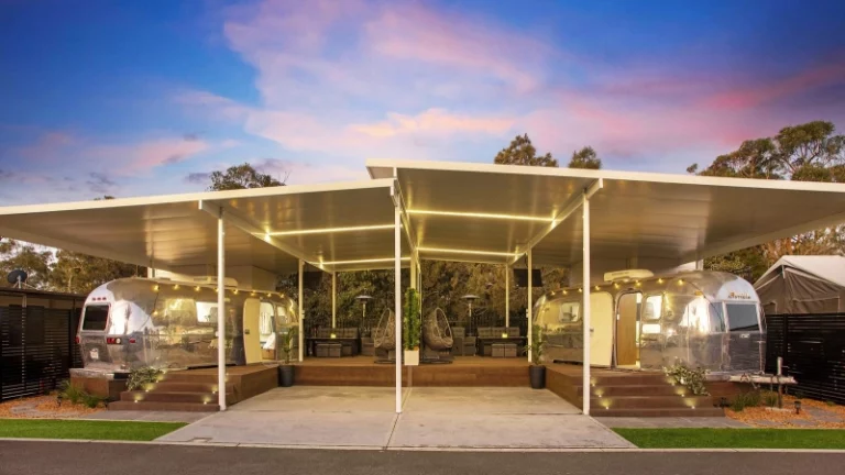 two airstream under car port structure with raise platform and seating area