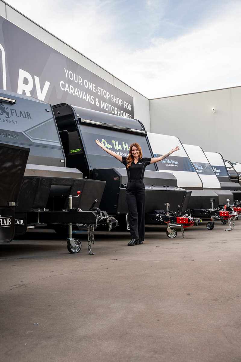 Person standing in front of a line of caravans at 4K RV.