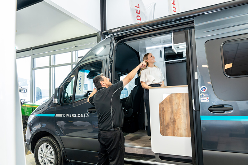 Person being shown the inside of a campervan by a salesperson at 4K RV.