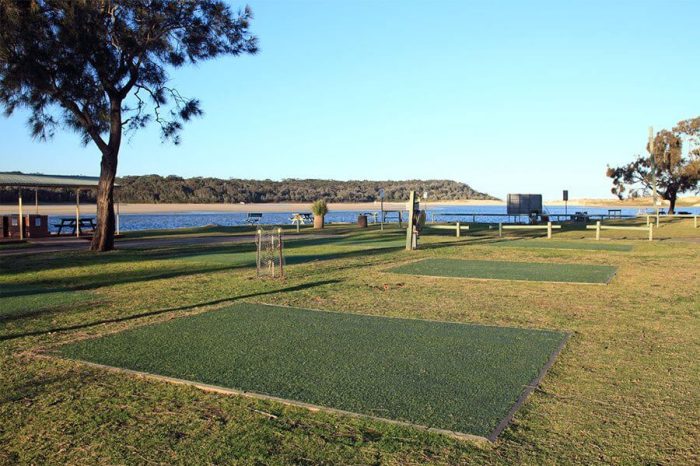 shot of empty camp site in park with water view