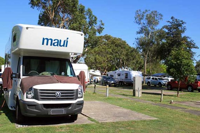motorhome on site with caravans behind